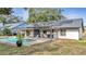 Exterior shot showcasing solar panels on the roof, a pool, and an outdoor kitchen area at 2417 Liela Lee Ct, Ocoee, FL 34761