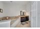 Bright bathroom features a soaking tub with tile surround and dark cabinets at 2417 Liela Lee Ct, Ocoee, FL 34761
