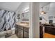 Bathroom featuring a shower with dark brown cabinets. Living room view at 2417 Liela Lee Ct, Ocoee, FL 34761