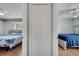 Bedrooms connected by closet. One bed has a blue blanket, the other a geometric quilt at 2417 Liela Lee Ct, Ocoee, FL 34761