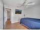 Bedroom features a blue bedspread, ceiling fan, and door to hallway at 2417 Liela Lee Ct, Ocoee, FL 34761