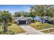 Well-maintained one-story home featuring a dark garage door, fresh landscaping, and a welcoming front yard at 2417 Liela Lee Ct, Ocoee, FL 34761