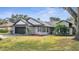 A charming single-story home with a well-manicured lawn, two-car garage, and a delightful yard at 2417 Liela Lee Ct, Ocoee, FL 34761