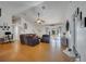 Spacious living room featuring hardwood floors, vaulted ceilings, and access to the outdoor pool at 2417 Liela Lee Ct, Ocoee, FL 34761