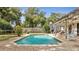 In-ground pool with brick patio, wooden pergola with outdoor bar and green grass at 2417 Liela Lee Ct, Ocoee, FL 34761