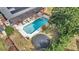 Aerial view of the backyard pool, shaded pergola, brick surround, and trampoline showcasing a private outdoor oasis at 2417 Liela Lee Ct, Ocoee, FL 34761