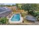 Inviting pool with brick surround, shaded pergola, and lush backyard, perfect for outdoor relaxation and Gathering fun at 2417 Liela Lee Ct, Ocoee, FL 34761