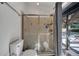 Glass-enclosed shower next to toilet, with outside view of the pool area at 2417 Liela Lee Ct, Ocoee, FL 34761