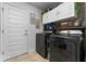 Bright laundry room with washer, dryer, and ample storage at 264 Citrus Pointe Dr, Haines City, FL 33844
