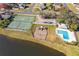 Aerial view of community amenities including tennis and basketball courts, playground, pool, and lake at 2715 Rismen Ct, Kissimmee, FL 34743