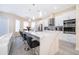 Modern kitchen with white cabinets and large island at 2715 Rismen Ct, Kissimmee, FL 34743