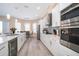 Modern kitchen with white cabinets, stainless steel appliances, and a wine cooler at 2715 Rismen Ct, Kissimmee, FL 34743