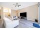 Bright living room featuring hardwood floors, a modern TV stand, and comfortable seating at 2715 Rismen Ct, Kissimmee, FL 34743