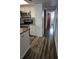 Galley kitchen with stainless steel appliances, granite countertops, and wood-look floors at 2741 N Poinciana Blvd # 43, Kissimmee, FL 34746