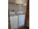 A laundry room includes a washer, dryer, and shelves for storage at 2741 N Poinciana Blvd # 43, Kissimmee, FL 34746