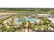 Community aerial showing a large pool area, a pond, a community center, and surrounding homes at 306 Hang Loose Way, Daytona Beach, FL 32124