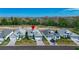 Beautiful overhead view of several colorful single-Gathering homes with manicured lawns at 306 Hang Loose Way, Daytona Beach, FL 32124