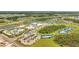 Aerial view of the community showing pools, sports courts, community buildings and surrounding homes at 306 Hang Loose Way, Daytona Beach, FL 32124