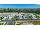 Aerial view of pastel single-Gathering homes with manicured lawns and brick paved driveways at 306 Hang Loose Way, Daytona Beach, FL 32124
