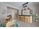 Charming bar area with wooden stools, decorative lighting, wine rack, and coastal decor at 306 Hang Loose Way, Daytona Beach, FL 32124