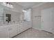 Bathroom featuring white dual sink vanity with granite countertops and a separate water closet at 306 Hang Loose Way, Daytona Beach, FL 32124