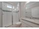 Bathroom featuring a large glass enclosed shower and white vanity with granite countertop at 306 Hang Loose Way, Daytona Beach, FL 32124