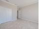 Bright bedroom featuring neutral walls, tiled floor, and a closet with double doors at 306 Hang Loose Way, Daytona Beach, FL 32124