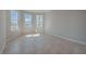 An empty bedroom with tile floors is bathed in sunlight from the bank of windows at 306 Hang Loose Way, Daytona Beach, FL 32124