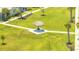 Aerial shot of a green common area featuring palm trees and thatched umbrella structures on manicured lawn at 306 Hang Loose Way, Daytona Beach, FL 32124