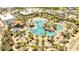 Aerial of the community pool with tiki huts and palm trees, surrounded by lounge chairs at 306 Hang Loose Way, Daytona Beach, FL 32124