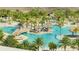 Aerial view of the community pool with beautiful palms and plenty of lounge chairs at 306 Hang Loose Way, Daytona Beach, FL 32124