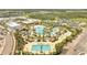 Aerial view of a community pool with a lazy river, tiki bars, and lounge seating areas at 306 Hang Loose Way, Daytona Beach, FL 32124