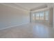 An empty room with tile floors and a large bay window that lets in plenty of light at 306 Hang Loose Way, Daytona Beach, FL 32124