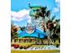 Attractive community entrance sign featuring a tower and colorful landscaping at 306 Hang Loose Way, Daytona Beach, FL 32124
