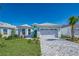 Charming single-Gathering home boasting a manicured lawn and brick paved driveway at 306 Hang Loose Way, Daytona Beach, FL 32124