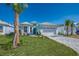 Beautiful single-Gathering home featuring tropical landscaping and a brick paved driveway at 306 Hang Loose Way, Daytona Beach, FL 32124