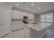 New kitchen with marble island, stainless steel appliances and white cabinetry at 306 Hang Loose Way, Daytona Beach, FL 32124