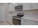 Kitchen with stainless steel oven, white cabinets, and stone countertop at 306 Hang Loose Way, Daytona Beach, FL 32124