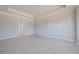 An empty living room featuring decorative ceilings, neutral paint, and tiled floors at 306 Hang Loose Way, Daytona Beach, FL 32124