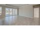 Spacious living room with tile floors, recessed lighting, and sliding glass doors leading to the patio at 306 Hang Loose Way, Daytona Beach, FL 32124