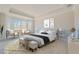This main bedroom boasts a decorative tray ceiling, lots of natural light, and neutral colors at 306 Hang Loose Way, Daytona Beach, FL 32124