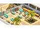 Overhead shot of a rooftop outdoor lounge area, featuring stylish furniture, tropical plants and lounge seating at 306 Hang Loose Way, Daytona Beach, FL 32124