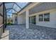 Spacious covered patio with brick pavers, pillar, and view of yard at 306 Hang Loose Way, Daytona Beach, FL 32124
