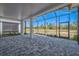 Covered patio with brick pavers, screened enclosure, and views of the backyard at 306 Hang Loose Way, Daytona Beach, FL 32124