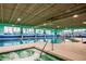 Indoor pool area with lap lanes, hot tub, and expansive windows at 306 Hang Loose Way, Daytona Beach, FL 32124
