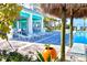Inviting pool area with lounge chairs, palm trees, and a tropical bar for relaxation and enjoyment at 306 Hang Loose Way, Daytona Beach, FL 32124