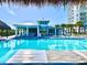 A large swimming pool at Latitude Margaritaville, complemented by poolside amenities and palm trees at 306 Hang Loose Way, Daytona Beach, FL 32124