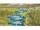 Aerial view of pristine blue tennis courts surrounded by lush landscaping at 306 Hang Loose Way, Daytona Beach, FL 32124