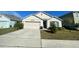 Two-story house with attached garage and landscaped yard at 3181 Serendipity Way, Davenport, FL 33896