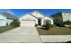 Well-maintained house with a two-car garage and manicured lawn at 3181 Serendipity Way, Davenport, FL 33896